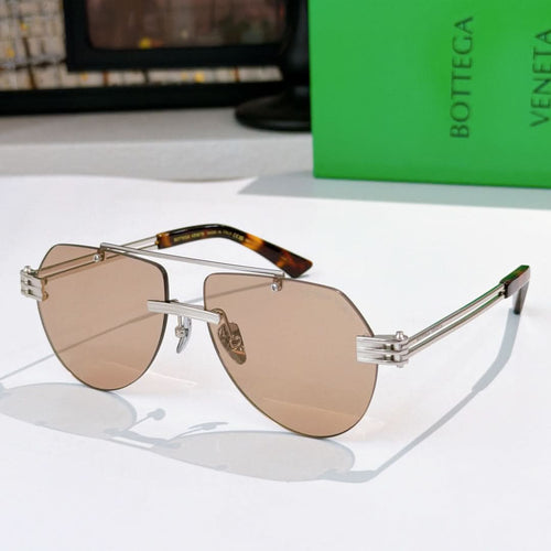 Sunglasses with light brown lenses, silver frame, and tortoise-accent temples