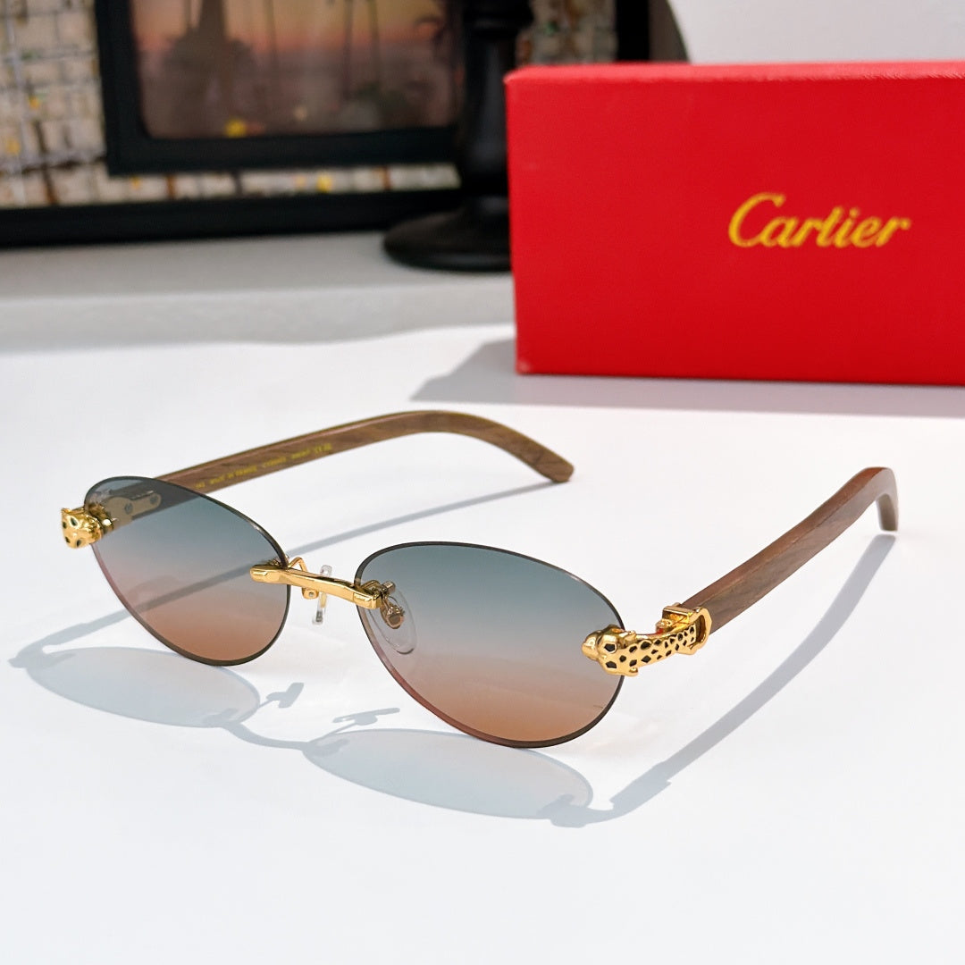 Gold-tone round sunglasses with amber lenses and ornate temple hardware