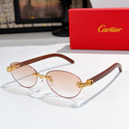 Gold-tone round sunglasses with light brown lenses and ornate temple detail