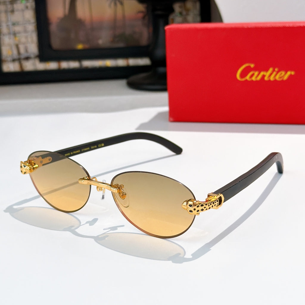 Gold-tone round sunglasses with yellow-tinted lenses and decorative temple detail
