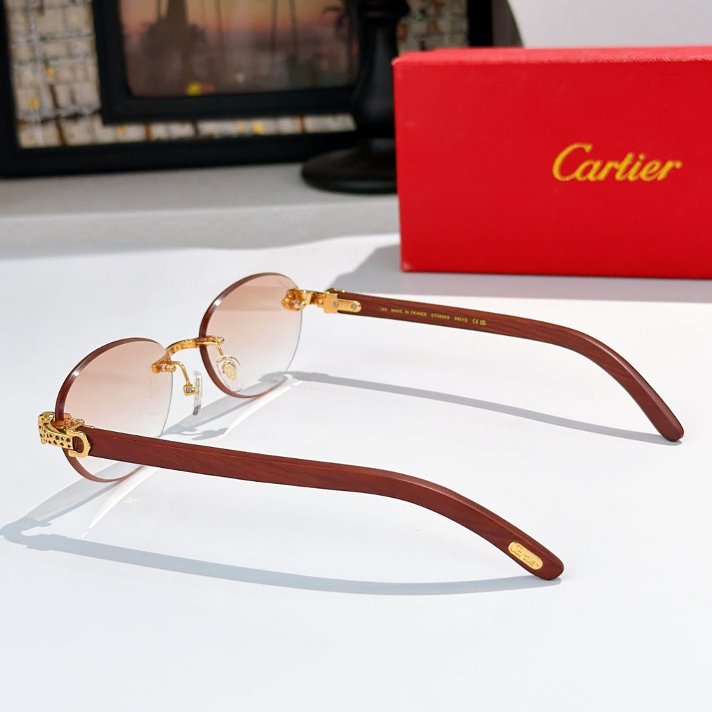 Brown and gold round sunglasses with clear lenses and engraved temple hardware