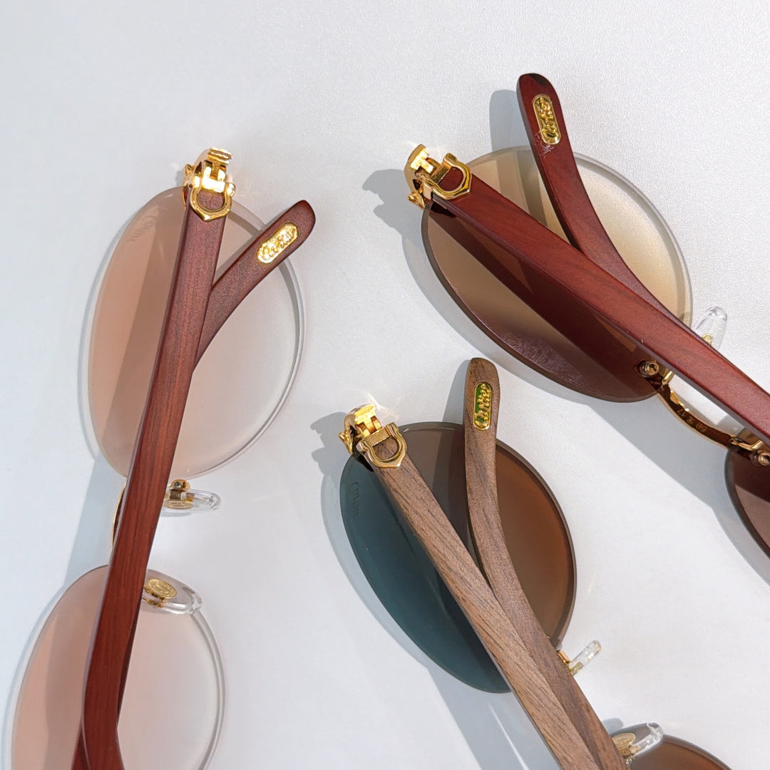 Gold-tone sunglasses with wood-look temples and ornate hinge hardware