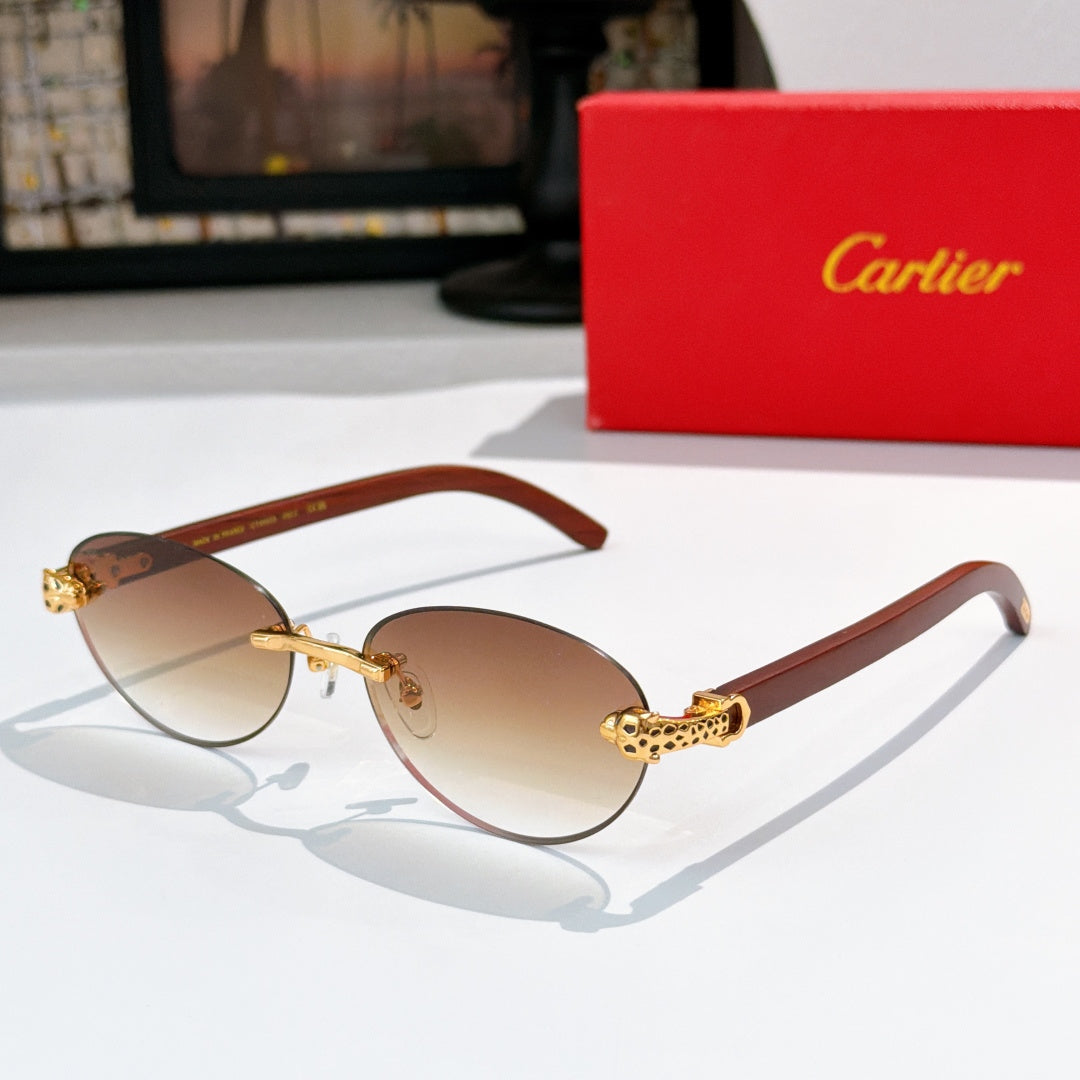 Gold-tone round sunglasses with brown gradient lenses and engraved temple detail