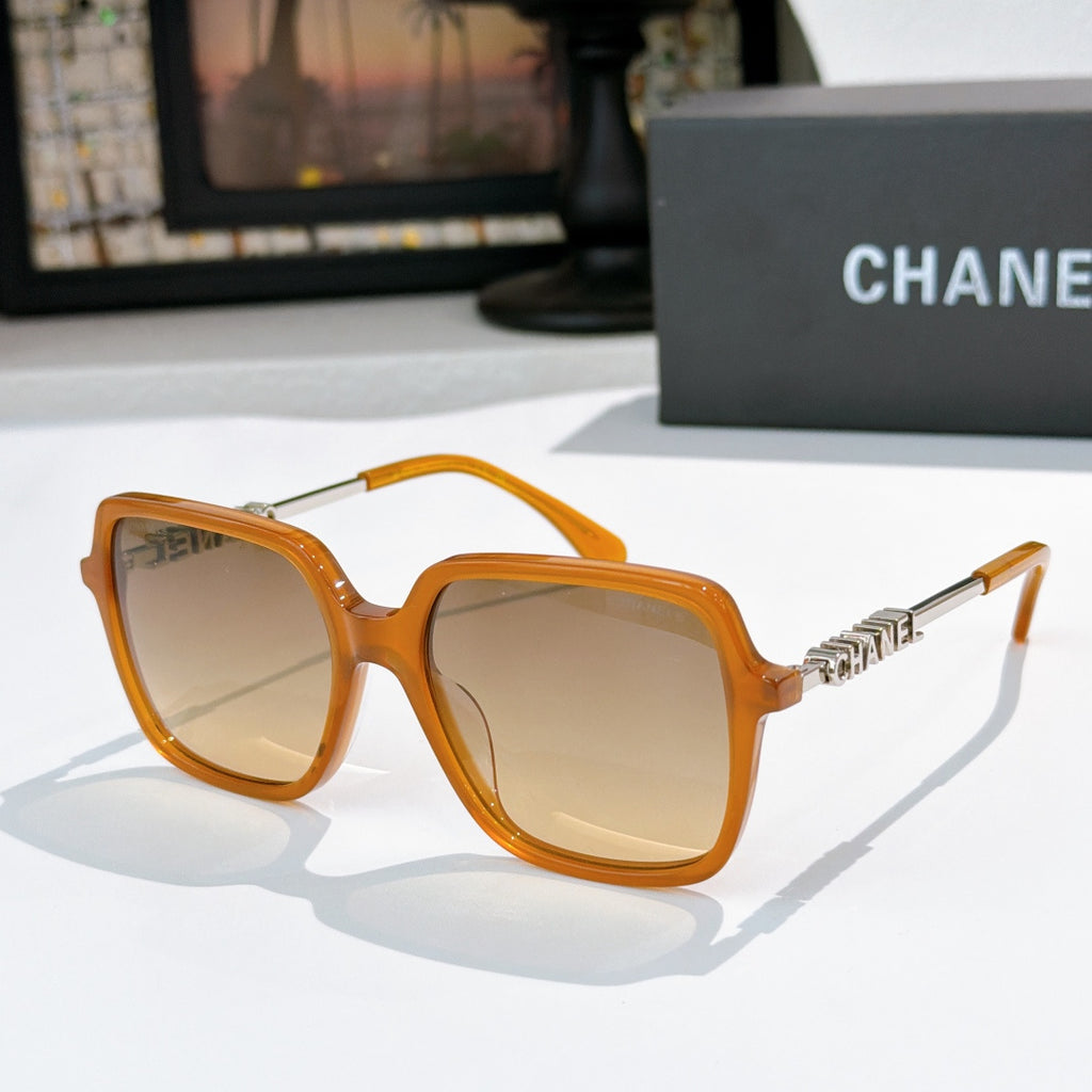 Orange sunglasses with amber lenses and gold logo temple detail