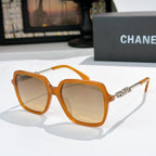 Orange sunglasses with amber lenses and gold logo temple detail