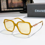 Amber sunglasses with clear lenses and gold logo temple detail