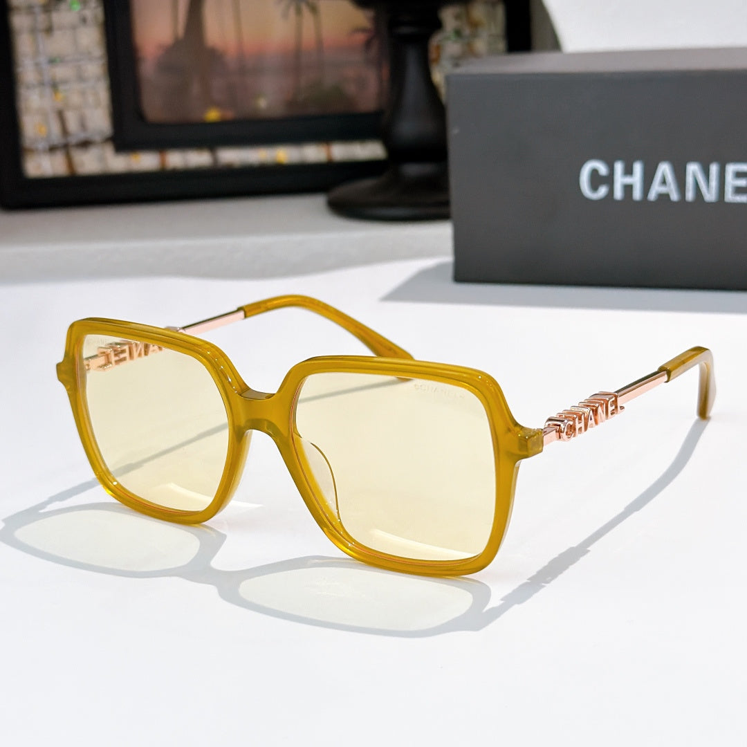 Amber sunglasses with clear lenses and gold logo temple detail
