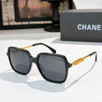 Dark tortoiseshell sunglasses with gray lenses and gold logo detail temples