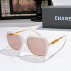 Clear white sunglasses with pink-tinted lenses and gold logo temples