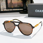 Sunglasses with tortoiseshell frame, brown tinted lenses, and gold-tone temple details