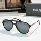 Sunglasses with black frame, gray tinted lenses, and silver-tone temple details
