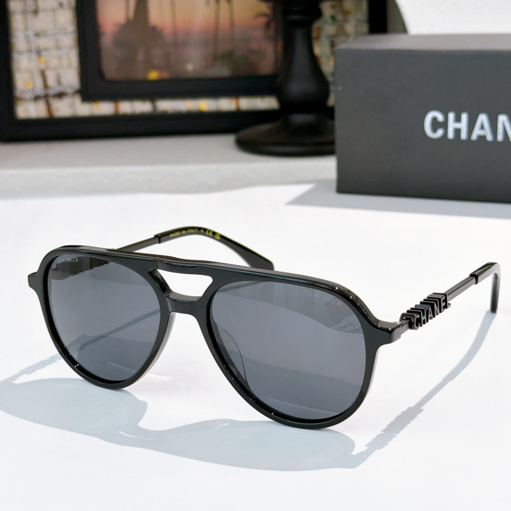 Sunglasses with black frame, gray tinted lenses, and black-tone temple details