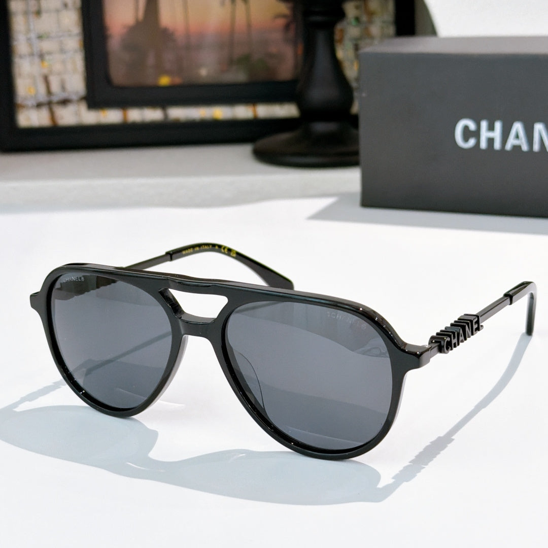 Sunglasses with black frame, gray tinted lenses, and black-tone temple details