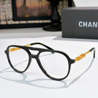 Eyeglasses with black frame and gold-tone temple accents, clear lenses