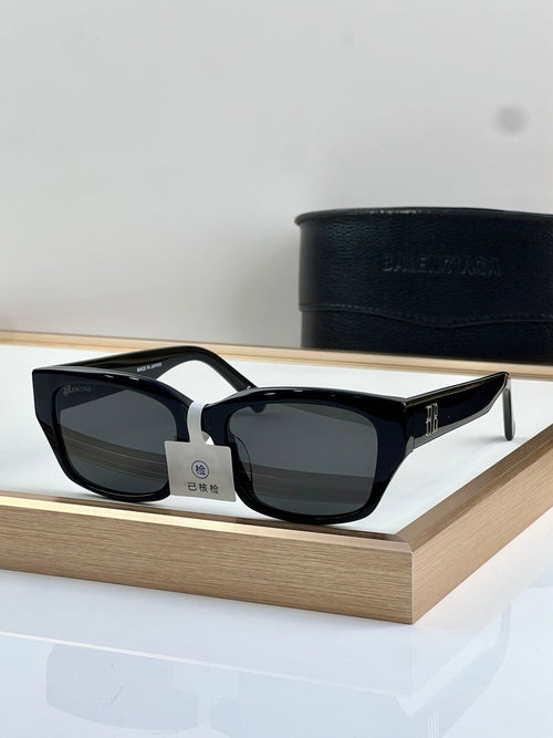 Balenciaga sunglasses with black frame, white accents, dark lenses