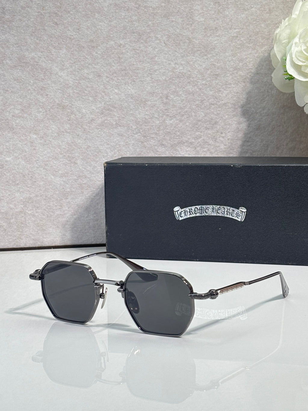 Chrome sunglasses with dark lenses and silver frame, side angle