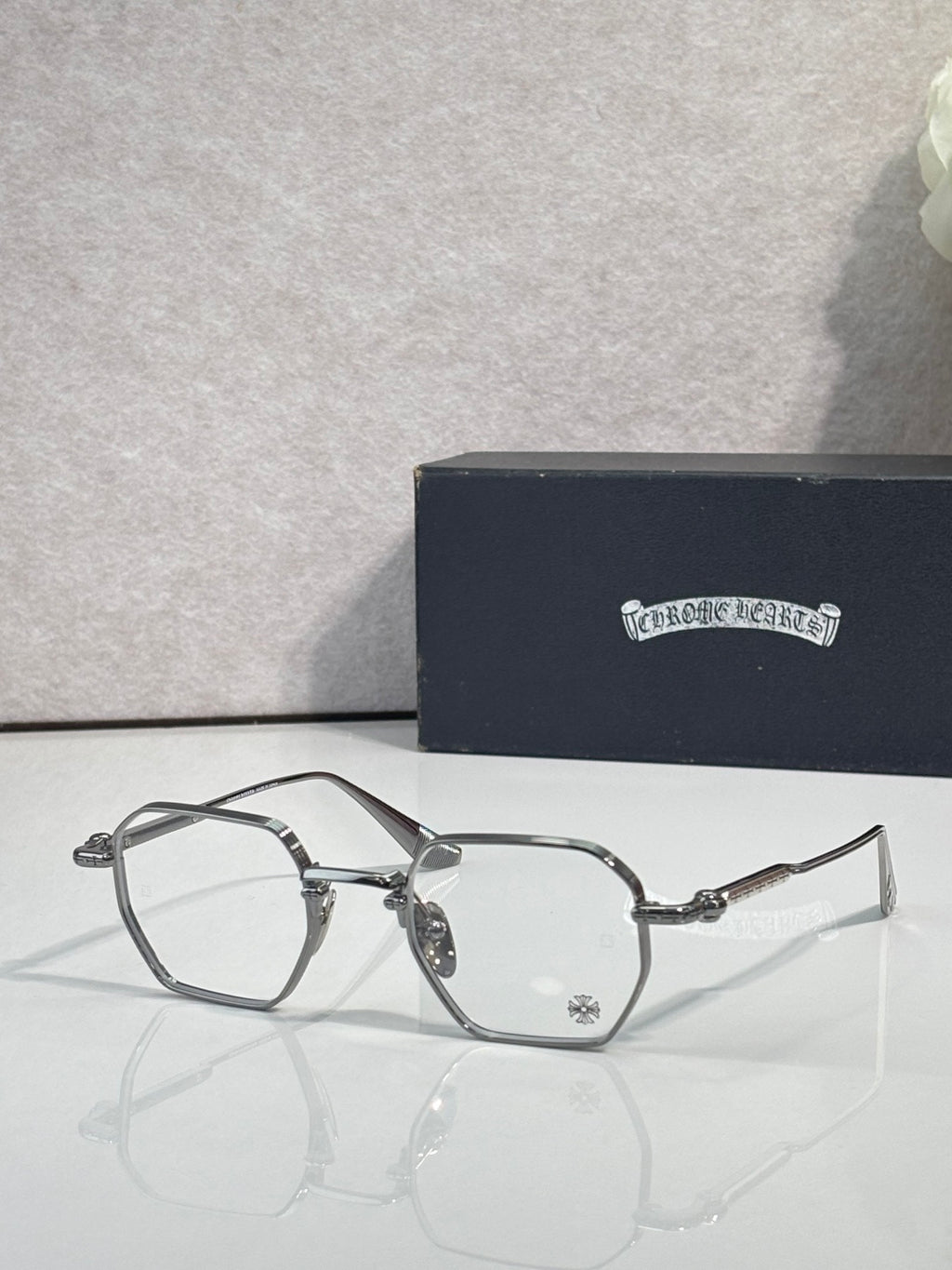 Dark metal rectangular eyeglasses with clear lenses and ornate bridge hardware