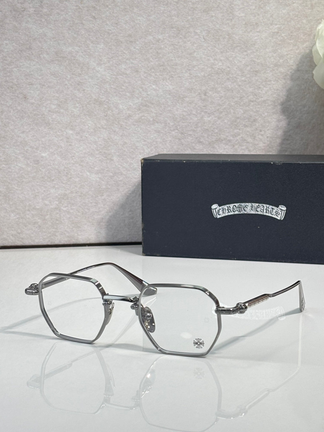 Dark metal rectangular eyeglasses with clear lenses and ornate bridge hardware