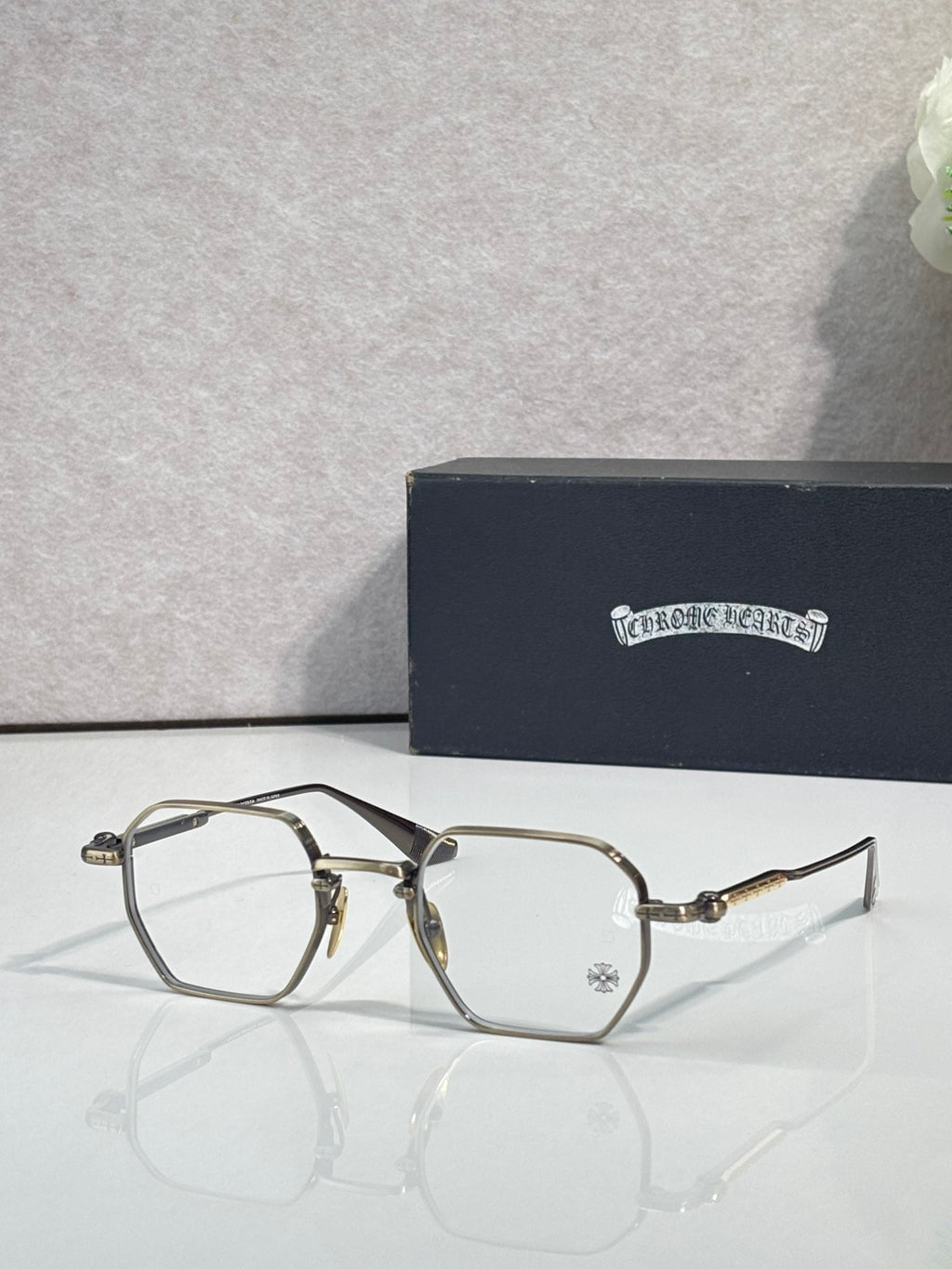 Dark and gold-tone rectangular eyeglasses with clear lenses
