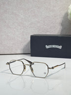 Dark and gold-tone rectangular eyeglasses with clear lenses