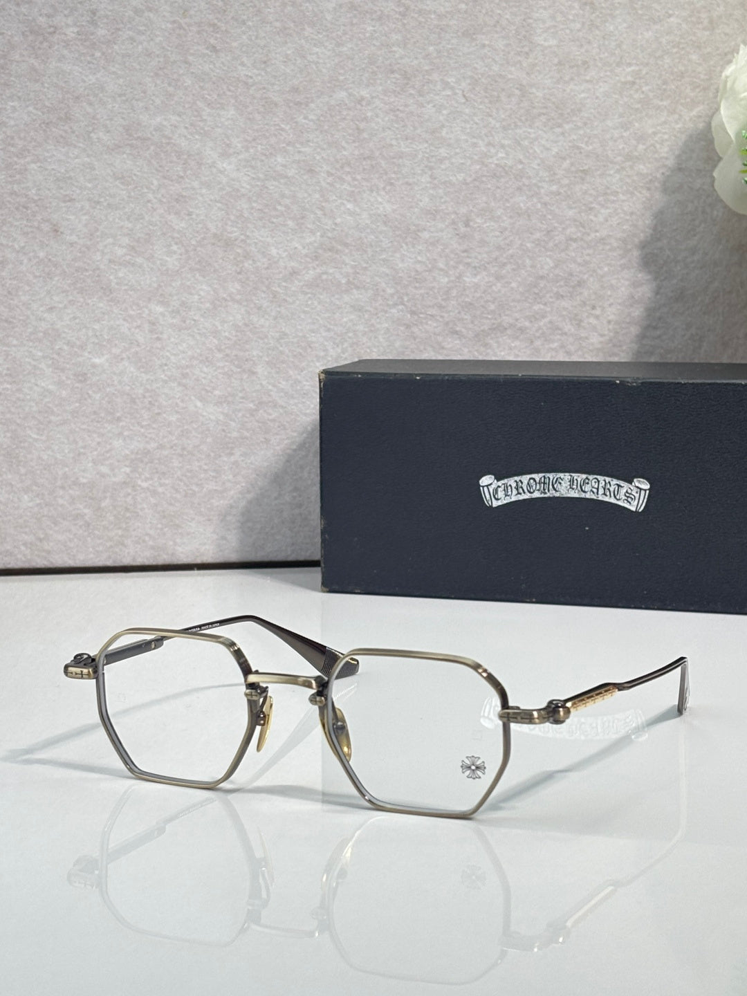 Dark and gold-tone rectangular eyeglasses with clear lenses