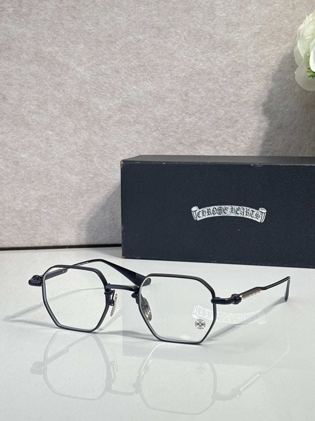 Black and silver rectangular eyeglasses with clear lenses and metal temple arms