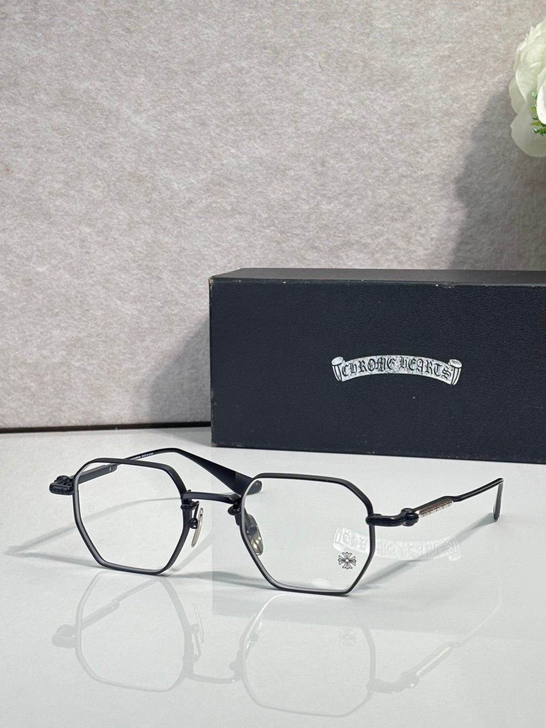 Black and silver rectangular eyeglasses with clear lenses and metal temple arms