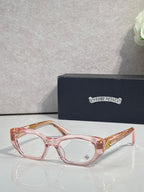 Chrome glasses with pink frame, round-square clear lenses, and decorative hinges.