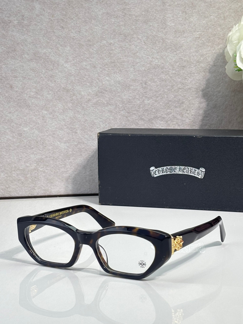 Chrome glasses with tortoiseshell dark frame, round-square clear lenses, and angled temples.