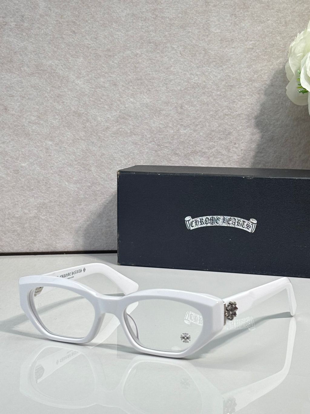 Chrome glasses with white frame, round-square clear lenses, and straight temples.