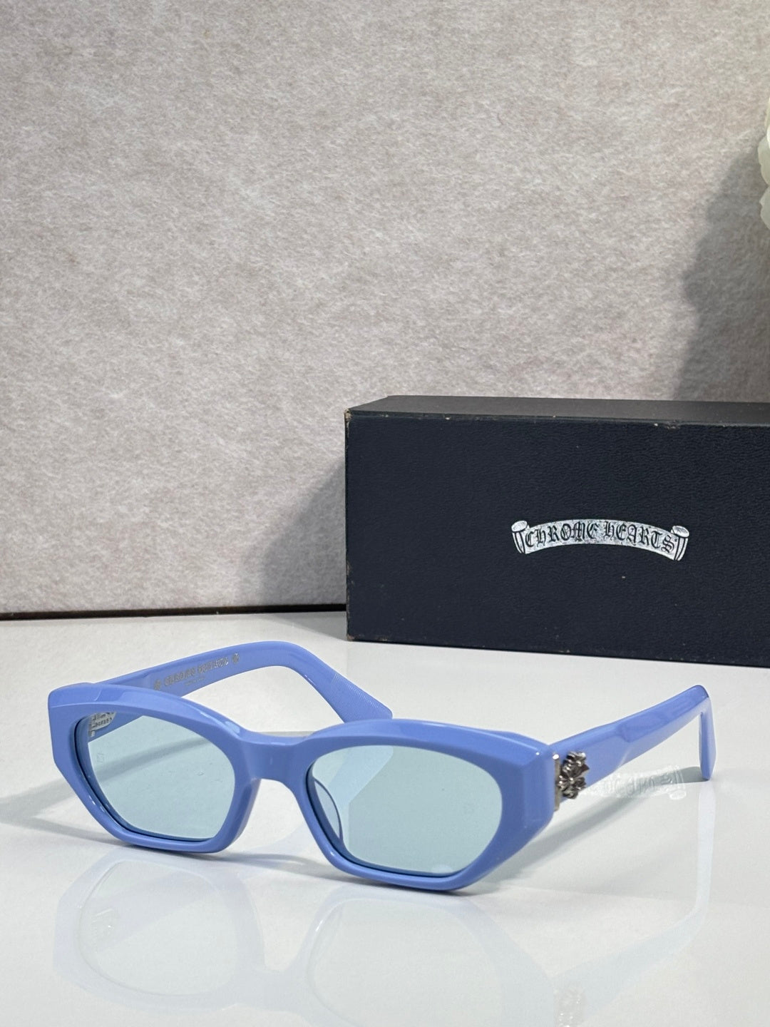 Blue and light blue glasses with pale blue lenses and metal temples