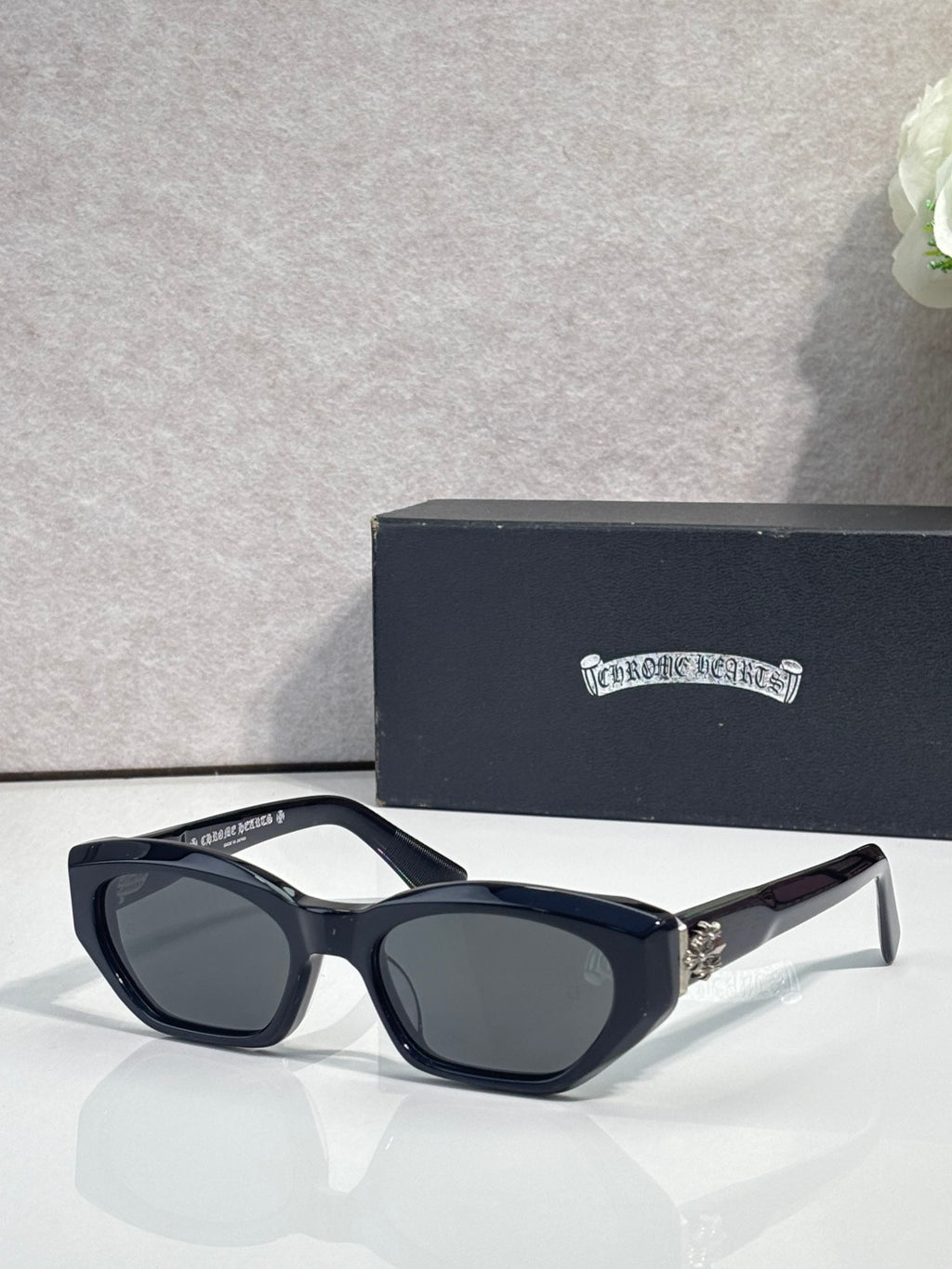 Black and clear glasses with dark lenses and chrome metal temples