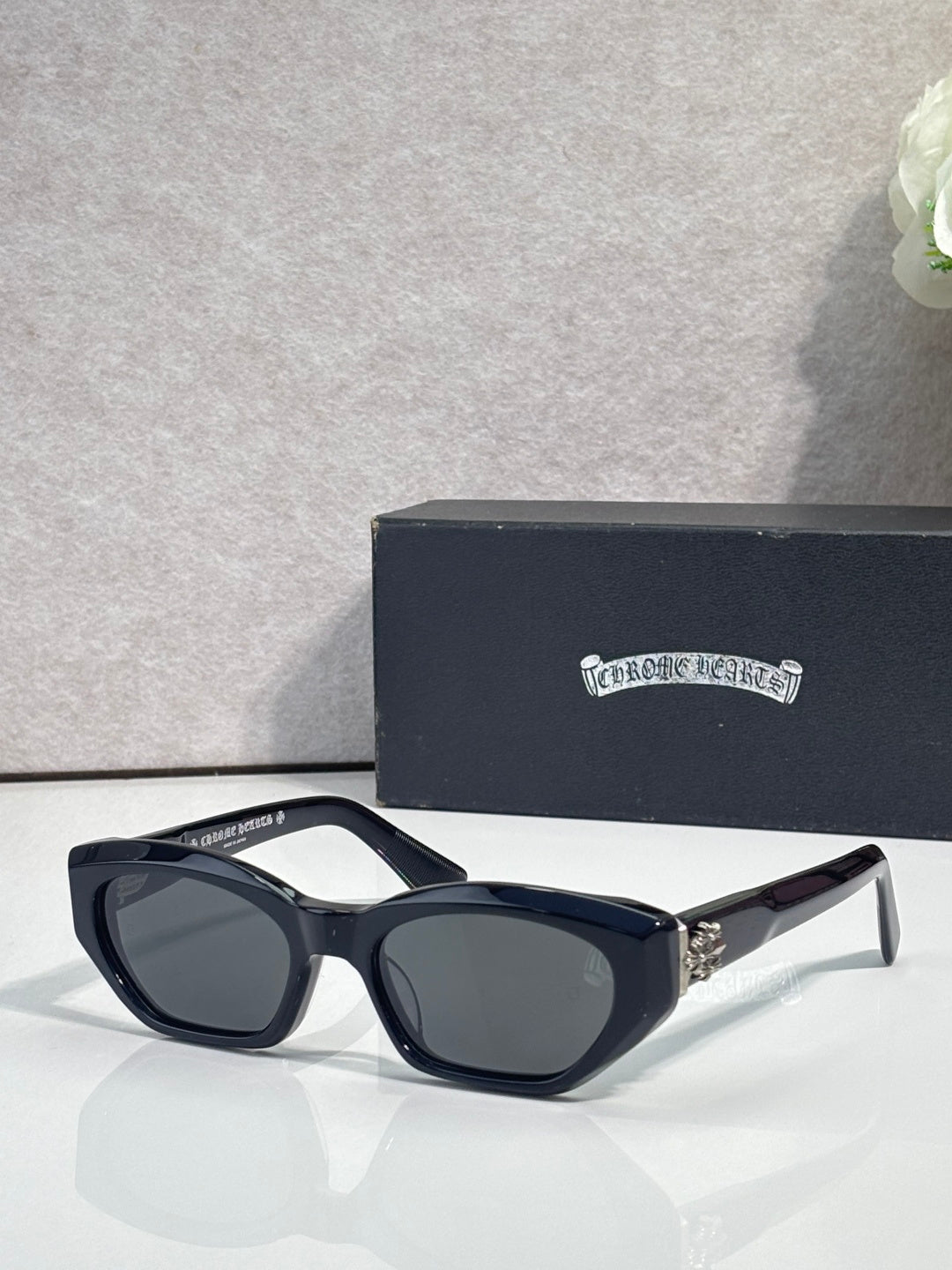 Black and clear glasses with dark lenses and chrome metal temples