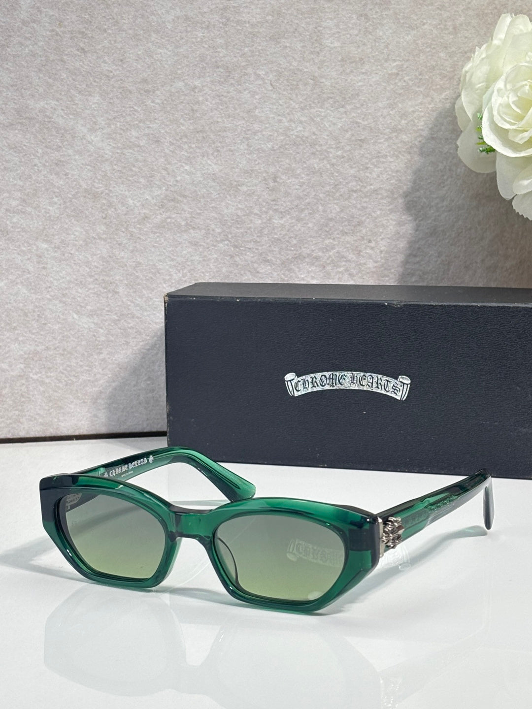 Green and clear acetate glasses with dark green lenses and chrome arms