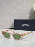 Pink and clear glasses with green lenses and gold-toned metal temples