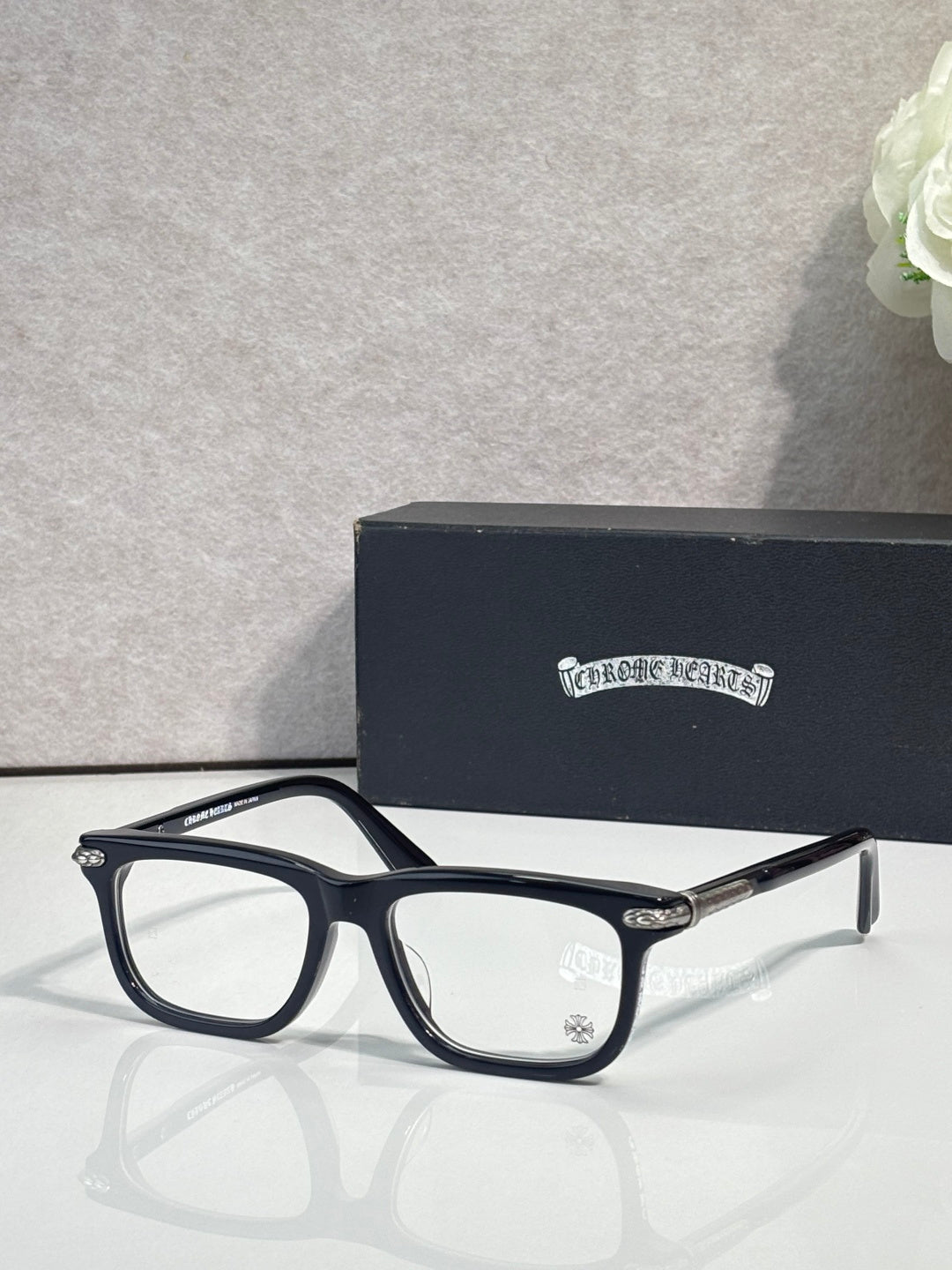 Chrome eyeglasses with dark-blue frame and clear lenses, metal bridge detail