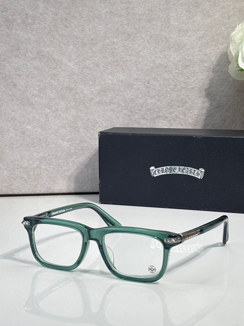 Chrome eyeglasses with green frame and clear lenses, metal temple tips