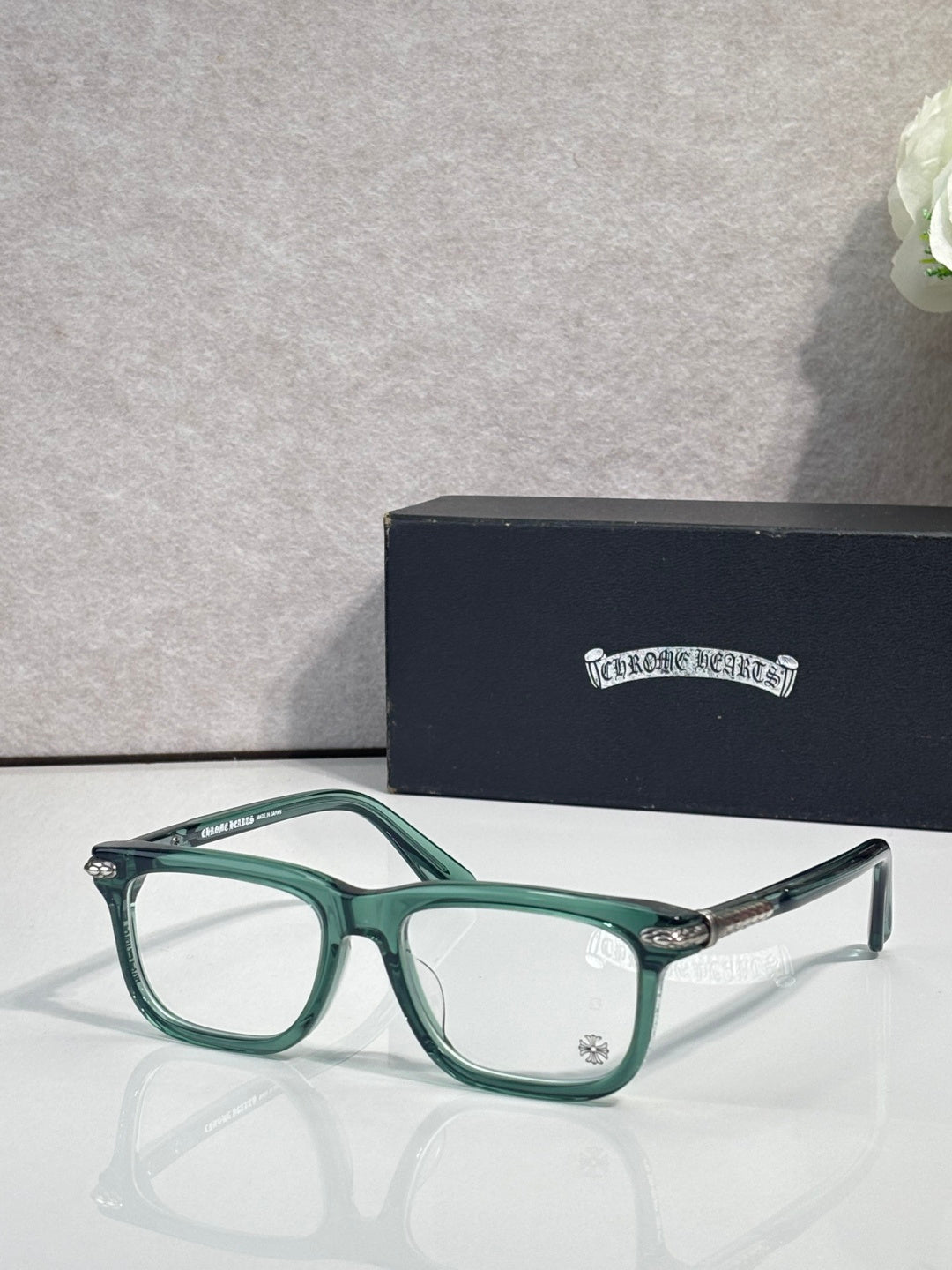 Chrome eyeglasses with green frame and clear lenses, metal temple tips