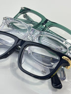 Chrome eyeglasses close-up of teal and clear frames with ornate metal hinges