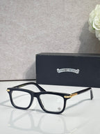 Chrome eyeglasses with dark frame and gold temple accents, clear lenses