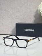 Chrome eyeglasses with dark frame and gold temple accents, clear lenses