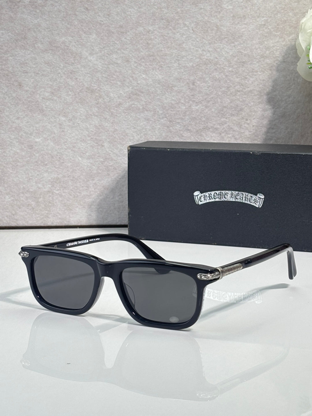 Dark blue eyeglasses with gray lenses and rectangular frames