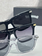 Eyeglasses close-up showing black and clear frames with gray-tinted lenses