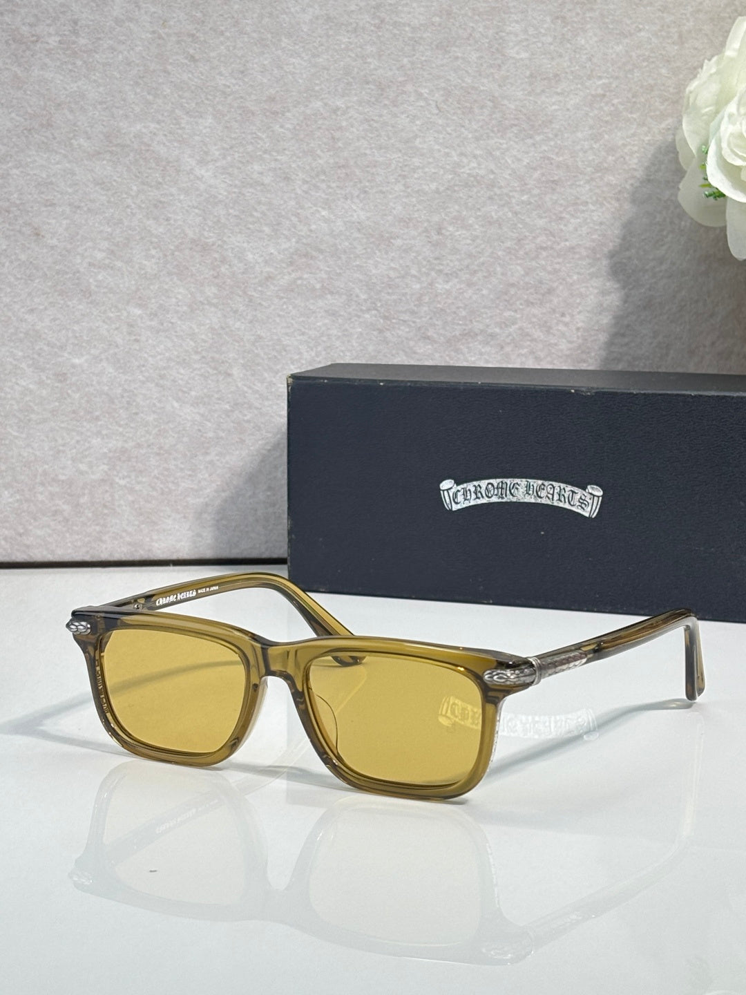Gold-toned eyeglasses with yellow lenses and rectangular frames