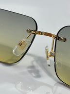 Versace glasses close-up: gold front, dark lens rim, Medusa emblem