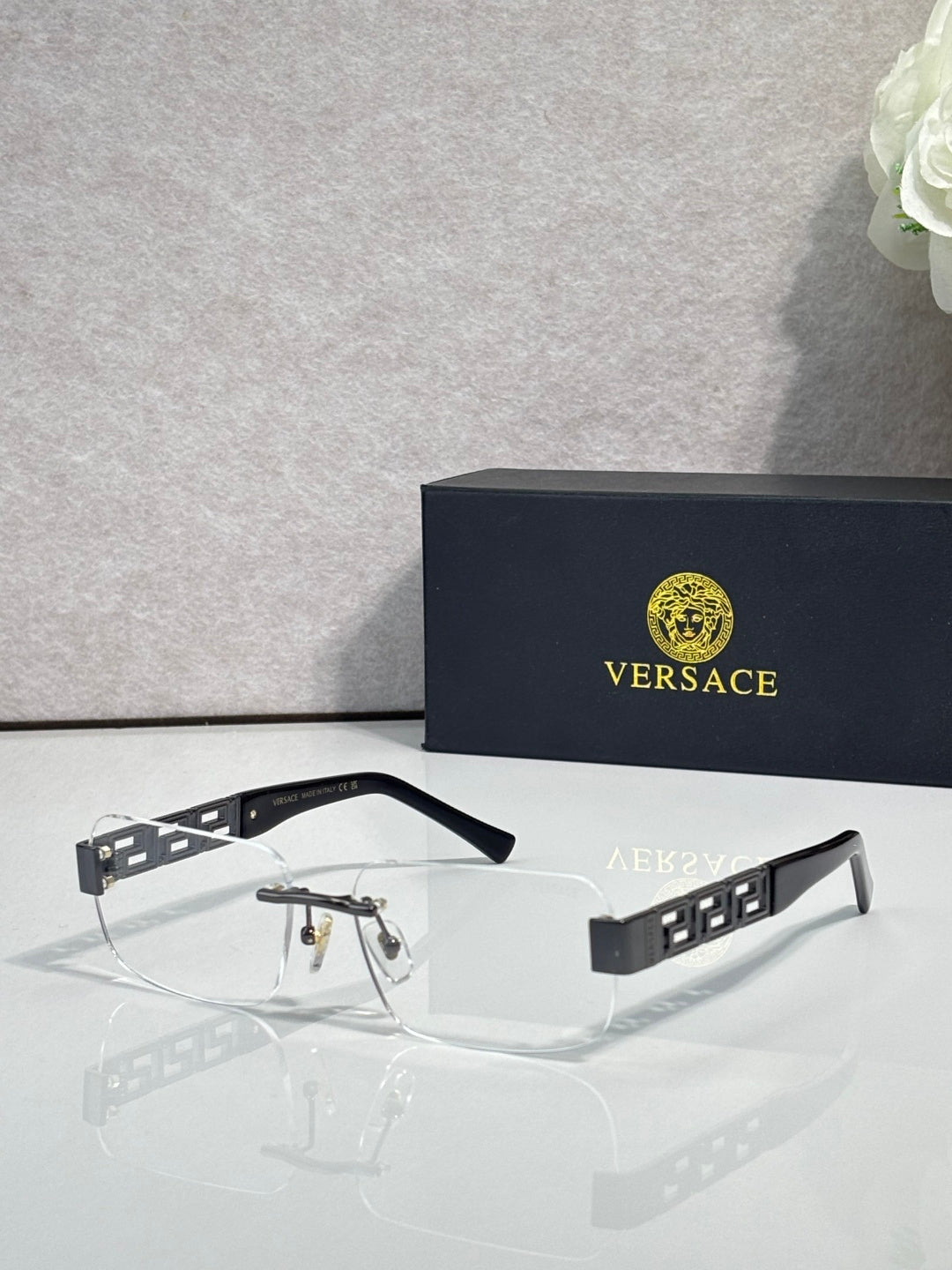 Versace glasses with clear lenses, dark frame, geometric temple pattern