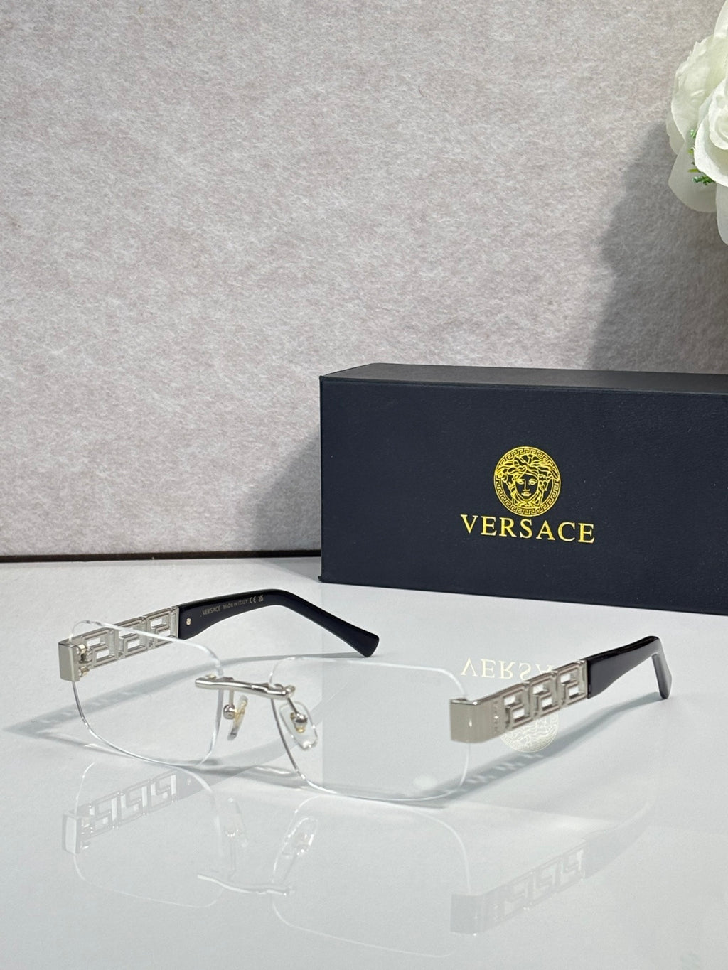 Versace glasses with clear lenses, dark frame, gold and silver geometric temple detail