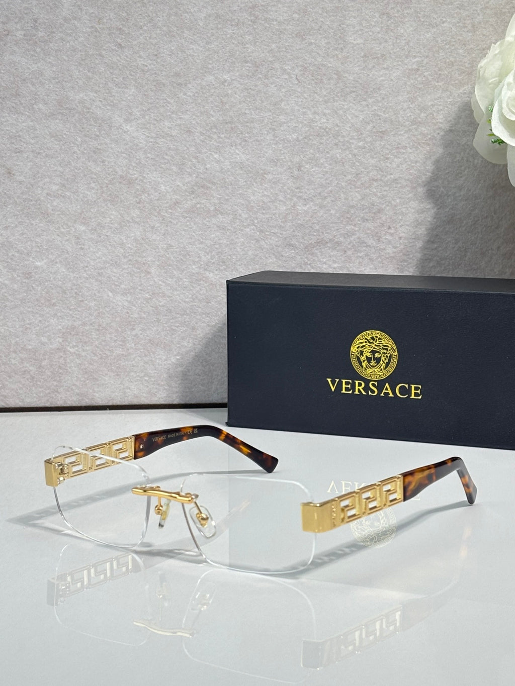 Versace glasses with clear lenses, tortoise temple, gold Medusa logo detail