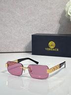 Black-frame sunglasses with pink tinted lenses and gold bar detail