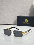 Black-frame sunglasses with dark lenses and gold bar accents